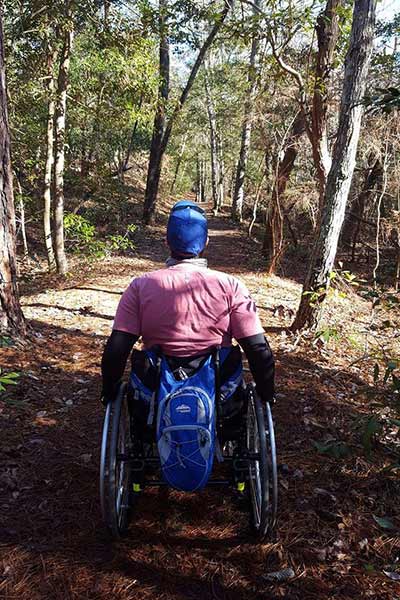 Man in a wheelchair on a trail at First Landing State Park