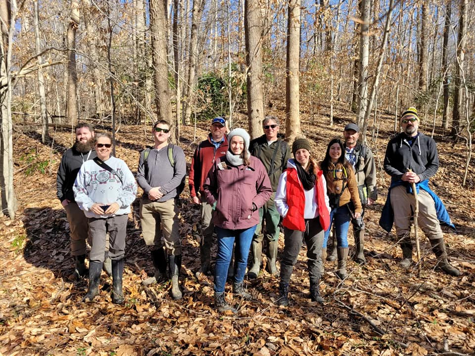 Staff from the Northern Virginia Conservation Trust, Virginia Department of Conservation & Recreation, and Stafford County in a group on a trail at Crow's Nest Natural Area Preserve. 
