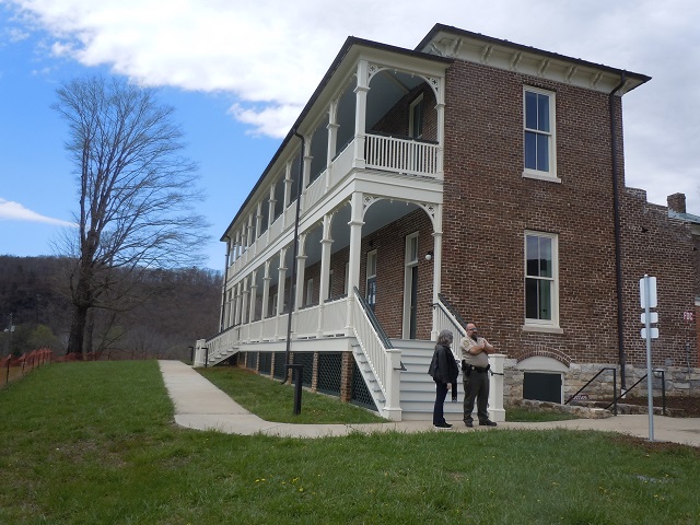 Side view of the Inn at Foster Falls with ranger and visitor