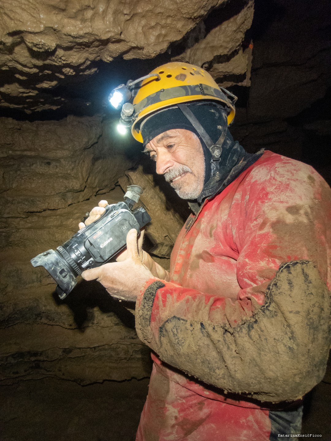 Dave Socky, writer, using a video camera in a cave.