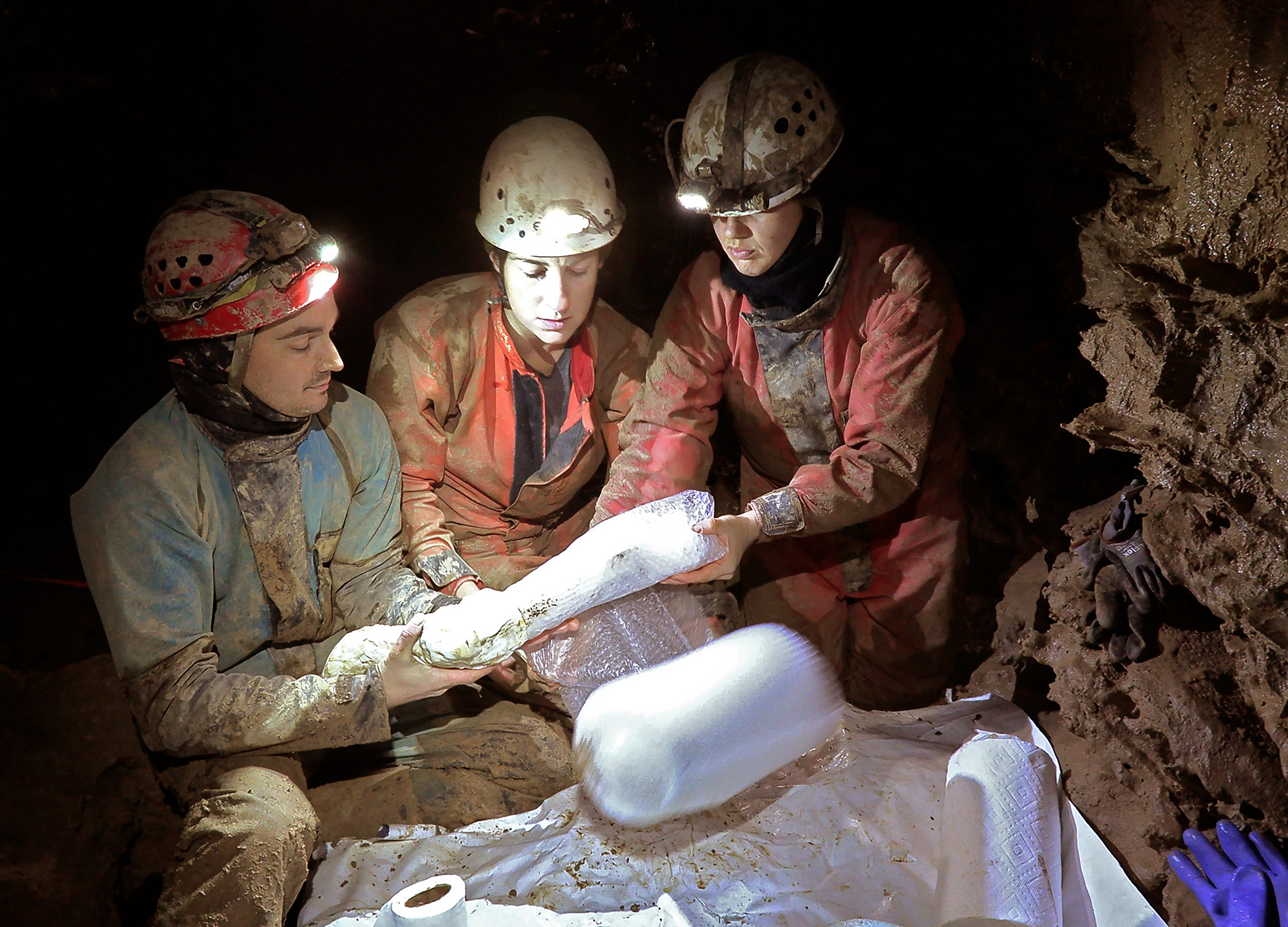 Alex, Katarina and Lauren carefully wrapping bones in protection like paper towels & bubble wrap.