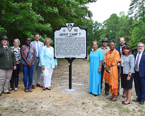 Group around the Group Camp 7 historical marker