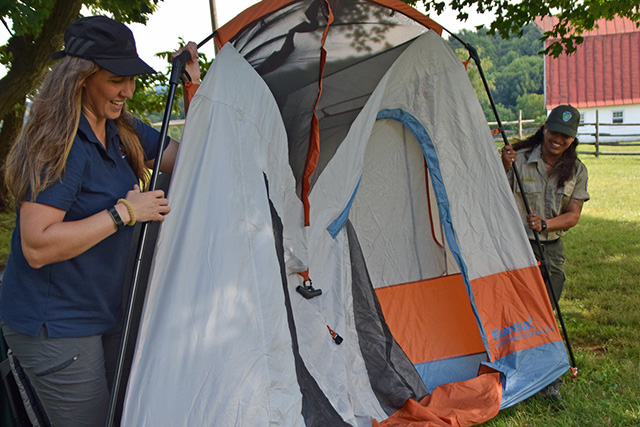 Instructors teaching participants about the basics of camping