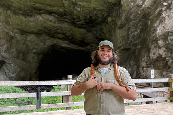 Ranger holding a snake